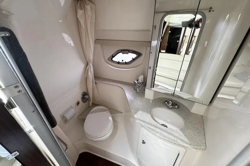 Slide: The Image of Bathroom interior of 2018 Regal 35 Sport Coupe with sink, toilet, and mirror. - 42