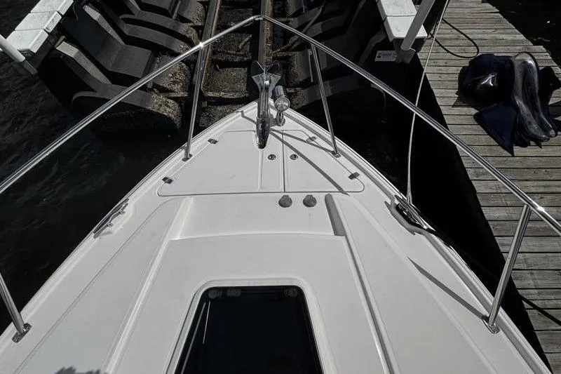 Slide: The Image of 2018 Regal 35 Sport Coupe bow view at dock, featuring sleek design and stainless steel railings. - 51