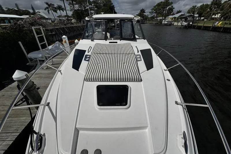 Slide: The Image of 2018 Regal 35 Sport Coupe docked by a scenic waterfront. - 53