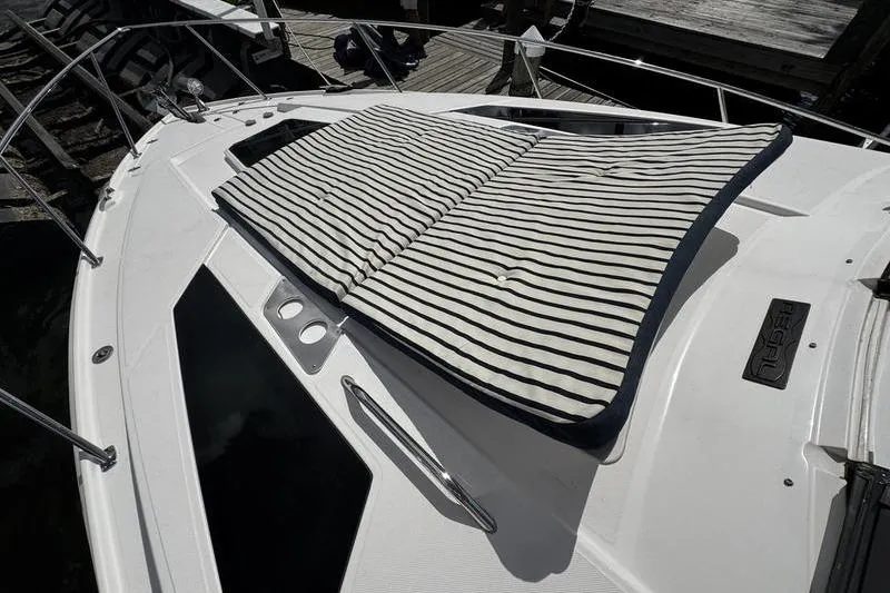 Slide: The Image of 2018 Regal 35 Sport Coupe with striped sun pad on deck. - 56