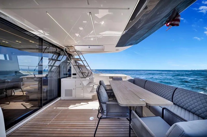 Slide: The Image of Luxurious 2022 Ferretti Yachts 670 deck with elegant seating and ocean view. - 26