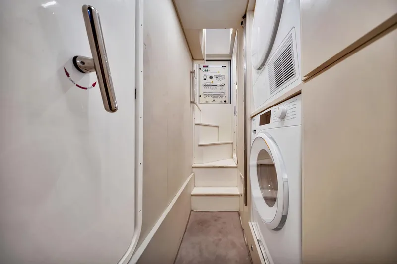 Slide: The Image of Laundry area inside 2022 Ferretti Yachts 670, featuring washer and dryer units. - 59