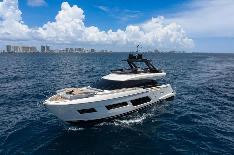 Slide: The Image of 2022 Ferretti Yachts 670 cruising on open sea with city skyline in background. - 69