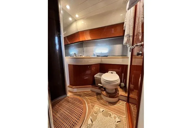 Slide: The Image of Luxurious bathroom in 2003 Viking Princess 50 Sport Cruiser yacht, featuring elegant wood finishes. - 13