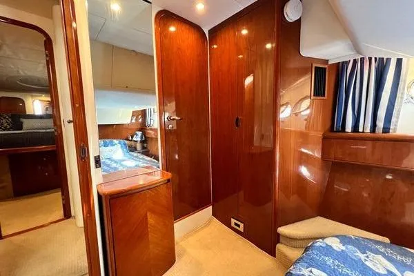Slide: The Image of Luxurious interior of 2003 Viking Princess 50 Sport Cruiser with polished wood finishes. - 16