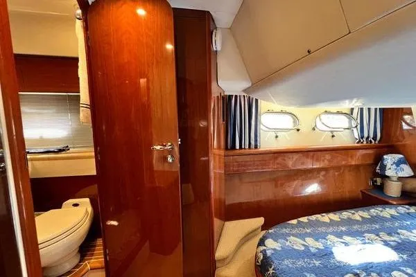 Slide: The Image of 2003 Viking Princess 50 Sport Cruiser interior with bedroom and bathroom view. - 17