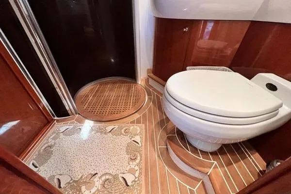 Slide: The Image of Luxurious bathroom in 2003 Viking Princess 50 Sport Cruiser with elegant wood accents. - 19