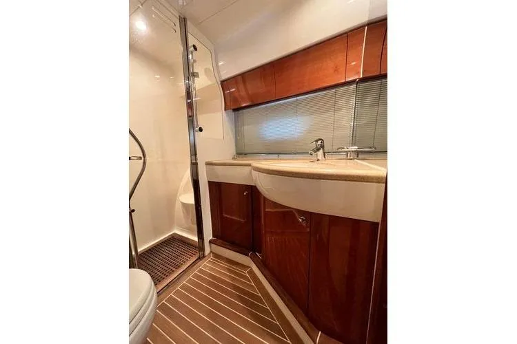 Slide: The Image of Luxurious bathroom in 2003 Viking Princess 50 Sport Cruiser with wood accents and modern fixtures. - 20