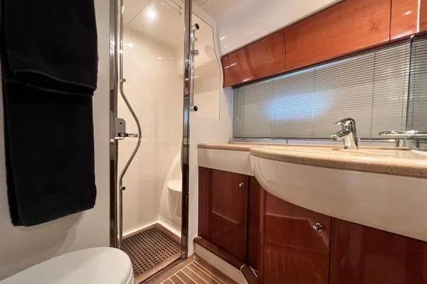 Slide: The Image of Luxurious bathroom in 2003 Viking Princess 50 Sport Cruiser with modern fixtures and wood accents. - 21