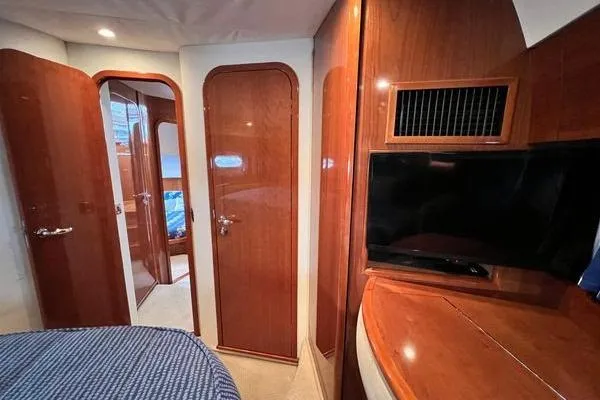 Slide: The Image of Interior of 2003 Viking Princess 50 Sport Cruiser with wood paneling and TV. - 23