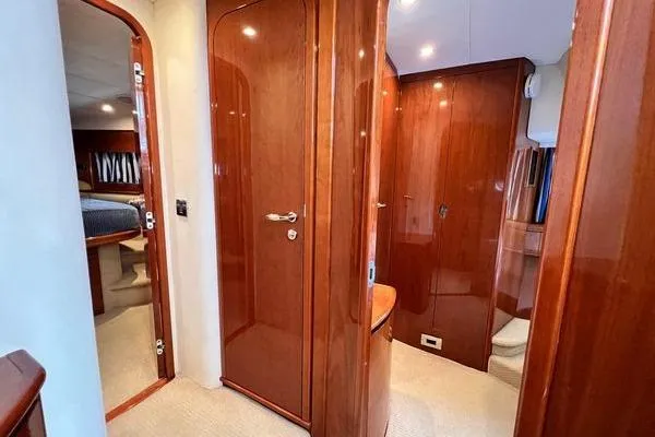 Slide: The Image of Luxurious interior of 2003 Viking Princess 50 Sport Cruiser with polished wood finishes. - 26