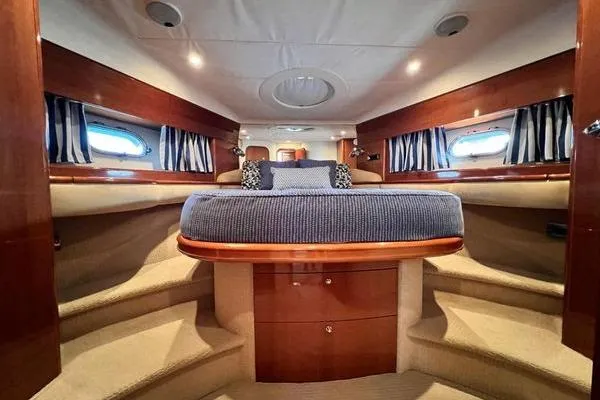 Slide: The Image of Luxurious interior of 2003 Viking Princess 50 Sport Cruiser with elegant wood finishes. - 29