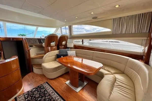 Slide: The Image of Luxurious interior of 2003 Viking Princess 50 Sport Cruiser with elegant seating and wooden finishes. - 3