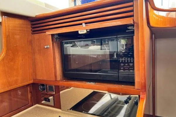 Slide: The Image of 2003 Viking Princess 50 Sport Cruiser kitchen with built-in microwave and stove. - 30