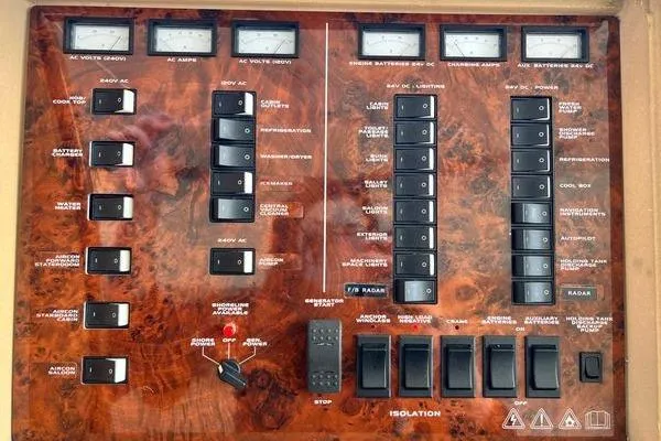Slide: The Image of Control panel of a 2003 Viking Princess 50 Sport Cruiser with switches and meters. - 31