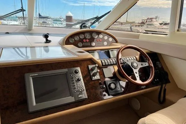 Slide: The Image of 2003 Viking Princess 50 Sport Cruiser helm with navigation equipment and wooden steering wheel. - 32