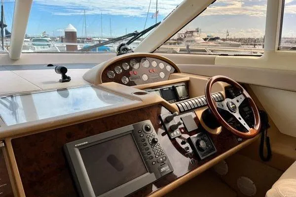 Slide: The Image of 2003 Viking Princess 50 Sport Cruiser helm with navigation equipment and steering wheel. - 34