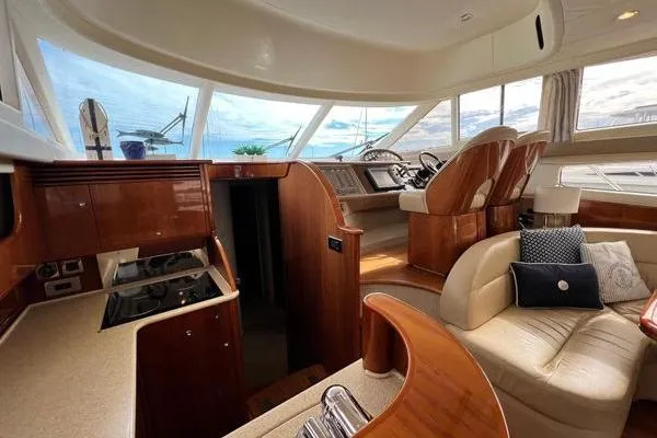 Slide: The Image of Luxurious interior of 2003 Viking Princess 50 Sport Cruiser with elegant seating and helm. - 36
