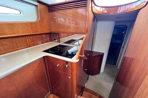 Slide: The Image of 2003 Viking Princess 50 Sport Cruiser kitchen with wood cabinetry and modern appliances. - 38