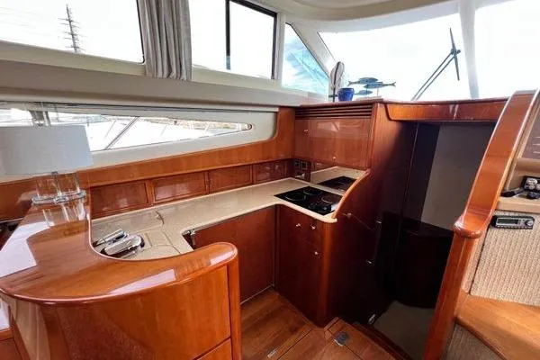 Slide: The Image of Luxurious 2003 Viking Princess 50 Sport Cruiser interior with elegant wood finish and modern amenities. - 40