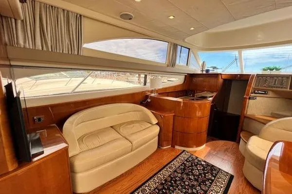 Slide: The Image of Luxurious interior of 2003 Viking Princess 50 Sport Cruiser with elegant seating and wood finishes. - 42