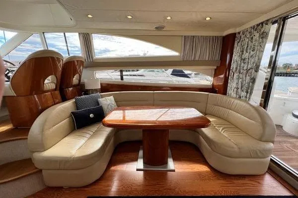 Slide: The Image of Luxurious interior of 2003 Viking Princess 50 Sport Cruiser with elegant seating and wooden table. - 43
