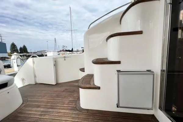 Slide: The Image of 2003 Viking Princess 50 Sport Cruiser with wooden deck and curved staircase. - 46