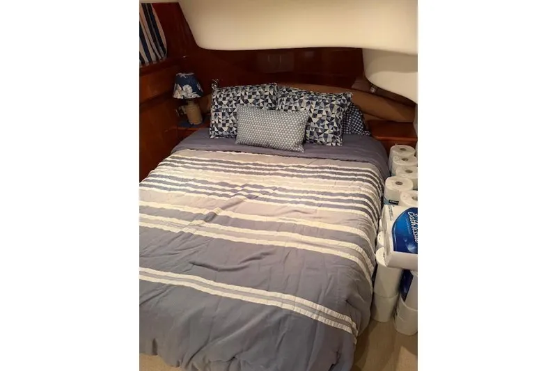 Slide: The Image of Cozy bedroom in 2003 Viking Princess 50 Sport Cruiser with striped bedding and decorative pillows. - 6