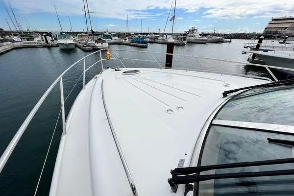 Slide: The Image of 2003 Viking Princess 50 Sport Cruiser docked in a marina, showcasing sleek deck design. - 7