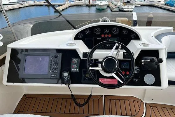 Slide: The Image of 2003 Viking Princess 50 Sport Cruiser helm with navigation equipment and steering wheel. - 9