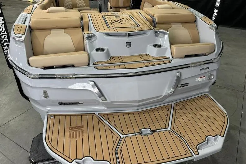 Slide: The Image of 2024 MasterCraft X24 boat with luxurious seating and teak-style decking. - 11