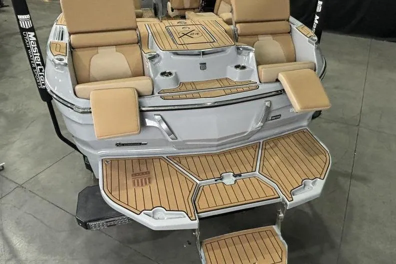 Slide: The Image of 2024 MasterCraft X24 boat with teak deck and luxurious seating. - 12