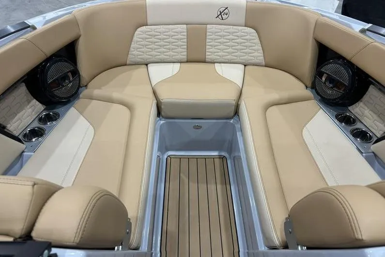Slide: The Image of 2024 MasterCraft X24 boat interior with beige seating and modern design. - 5