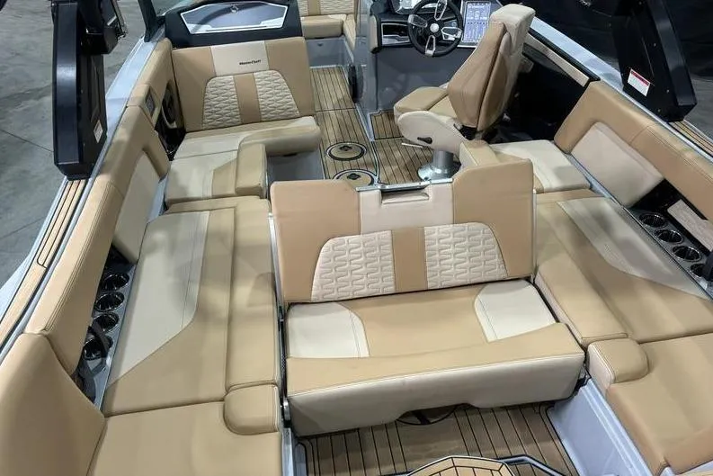 Slide: The Image of 2024 MasterCraft X24 boat interior with luxurious beige seating and modern dashboard. - 7