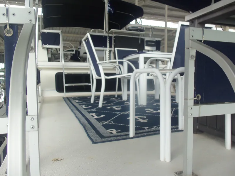 Slide: The Image of 2003 Gibson Classic boat deck with blue chairs and table set. - 15