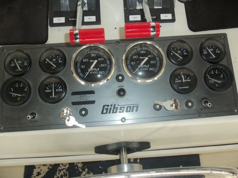 Slide: The Image of Control panel of a 2003 Gibson Classic boat with gauges and throttle levers. - 20