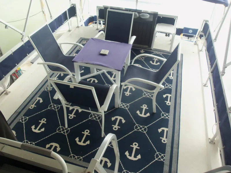 Slide: The Image of Outdoor seating area on a 2003 Gibson Classic boat with nautical-themed decor. - 23
