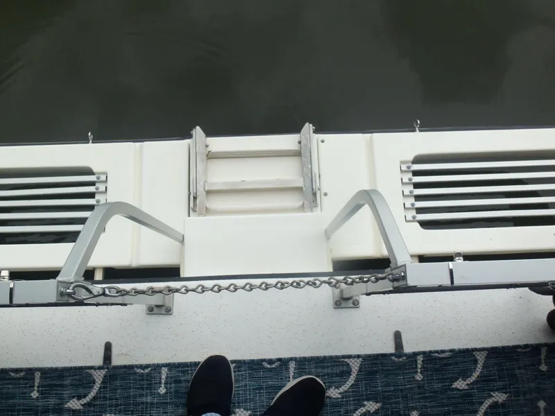 Slide: The Image of View from a 2003 Gibson Classic boat deck with steps and railing. - 24