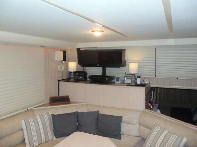 Slide: The Image of Cozy interior of a 2003 Gibson Classic boat with a TV and comfortable seating. - 32