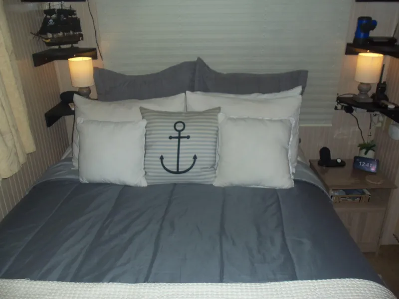Slide: The Image of Cozy bedroom with nautical-themed pillows and ambient lighting. - 38