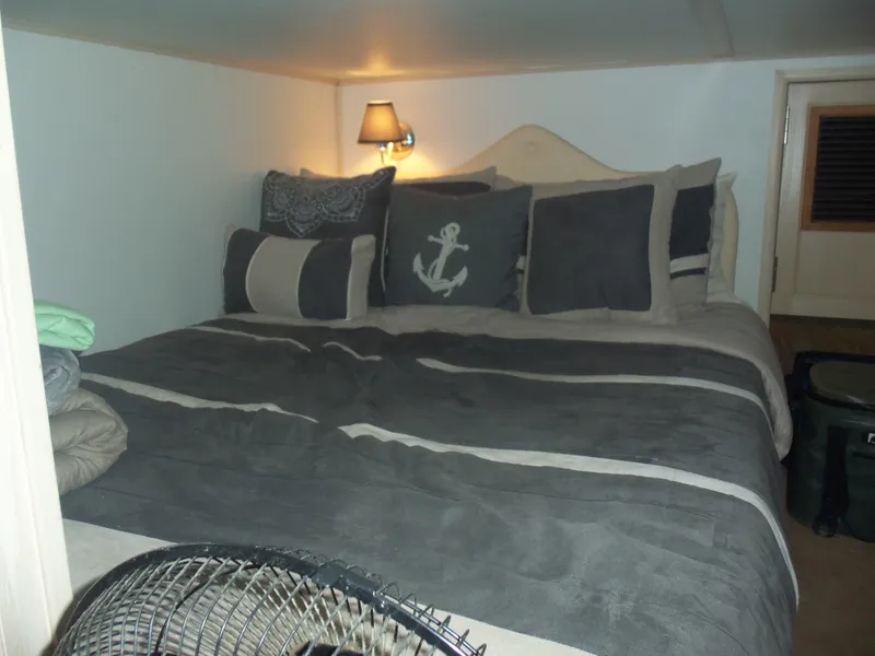Slide: The Image of Cozy bedroom with nautical-themed pillows and soft lighting, featuring a 2003 Gibson Classic design. - 46