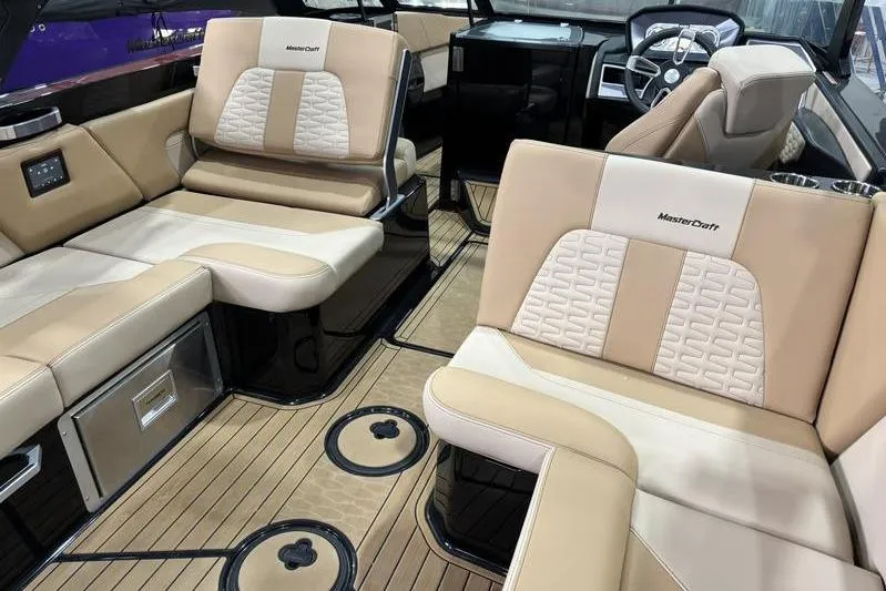 Slide: The Image of 2024 MasterCraft X26 boat interior with luxurious seating and modern design. - 11