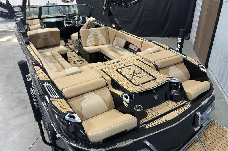 Slide: The Image of 2024 MasterCraft X26 boat interior with luxurious seating and modern design. - 17