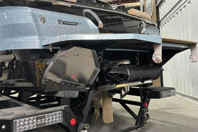 Slide: The Image of 2024 MasterCraft X26 boat rear view, showcasing supercharged engine and sleek design. - 19