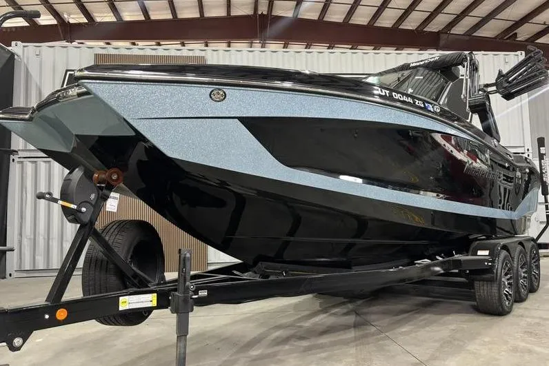 Slide: The Image of 2024 MasterCraft X26 boat on trailer in warehouse setting. - 3