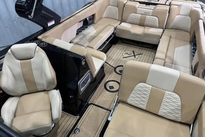 Slide: The Image of 2024 MasterCraft X26 boat interior with luxurious beige seating and modern design. - 7