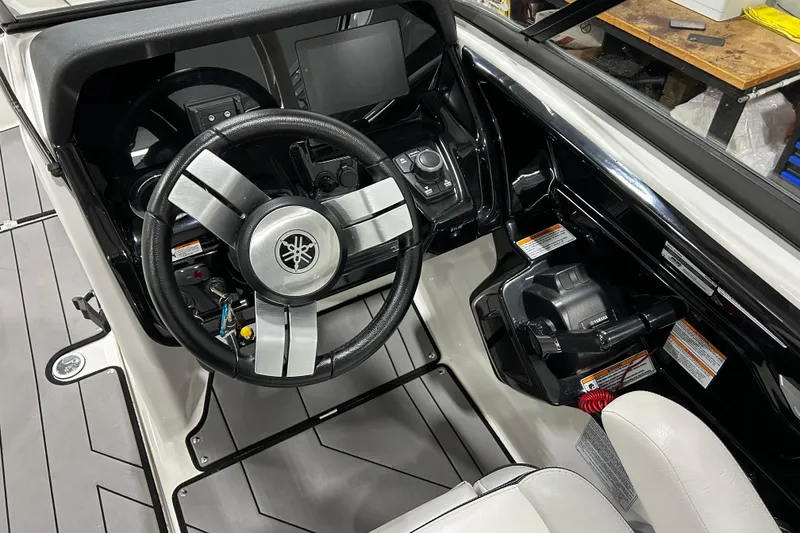 Slide: The Image of 2019 Yamaha Boats 212X cockpit with steering wheel and control panel. - 16