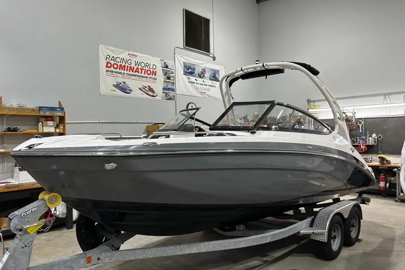 Slide: The Image of 2019 Yamaha Boats 212X on trailer in a workshop setting. - 2