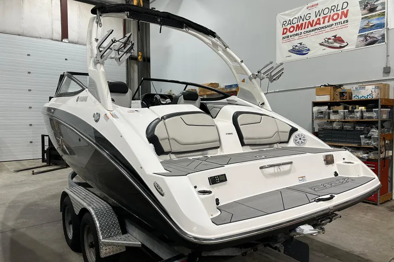 Slide: The Image of 2019 Yamaha Boats 212X in a garage, showcasing sleek design and modern features. - 4