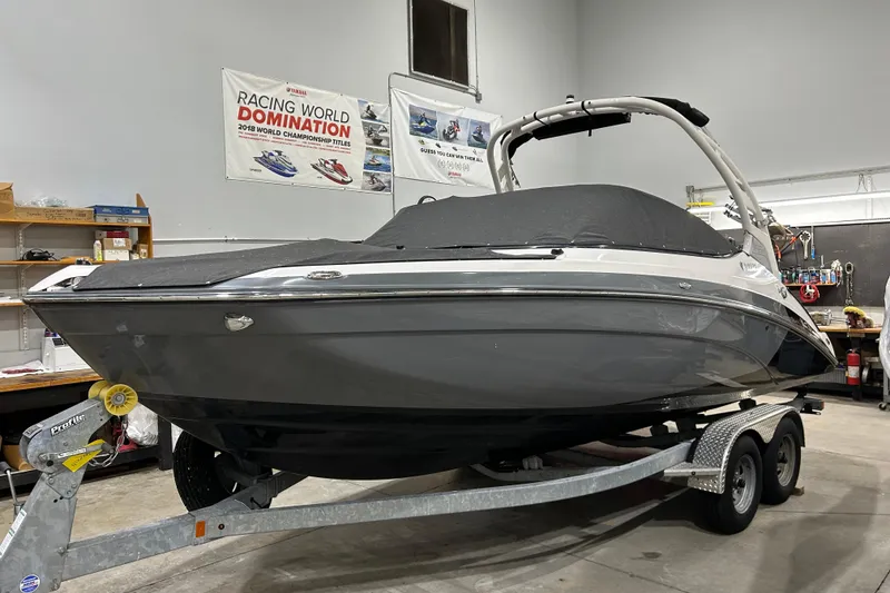 Slide: The Image of 2019 Yamaha Boats 212X on trailer in garage, covered and ready for transport. - 7